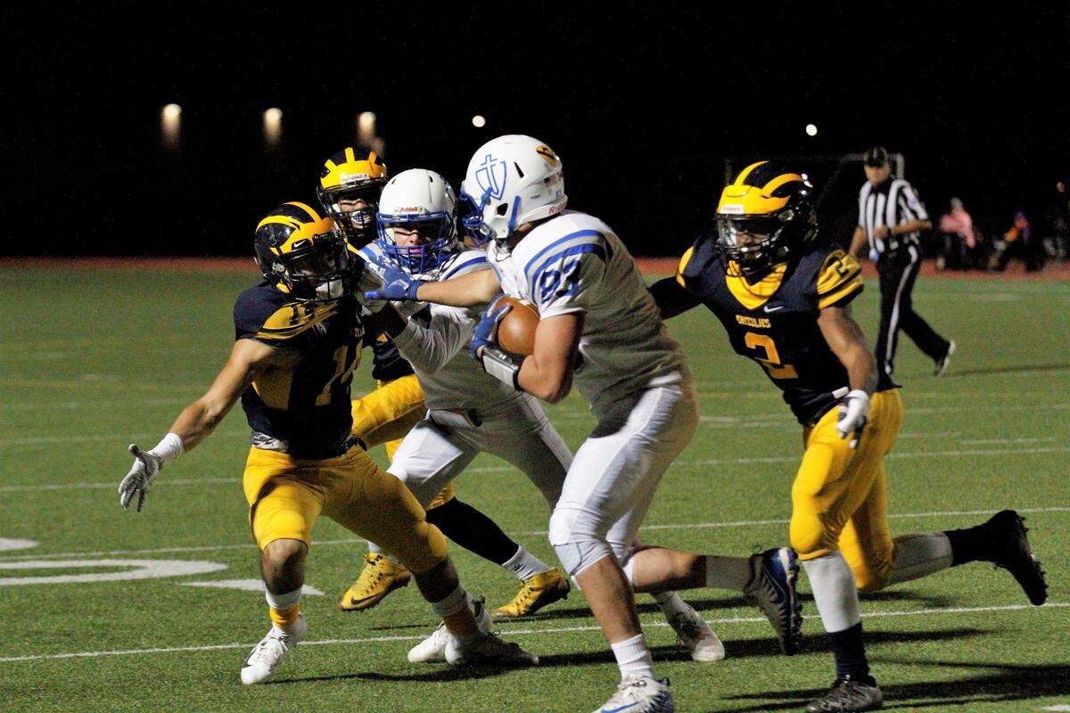 Kapaun’s Brendan Bhargava stiff arms a defender during the Crusaders’ 55-26 loss to Wichita Northwest on Friday. (Sept. 28, 2018)