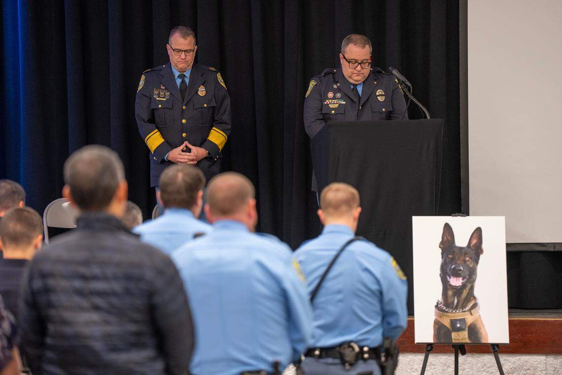 Sedgwick County Sheriff Jeff Easter, left, and Lt. Clayton Bush bow their heads during a moment of silence during a service honoring fallen Sedgwick County Sheriff’s Office K-9 Bane. Bane was killed on Nov. 16, 2023, after he was sent into a drainage pipe in an effort to apprehend a suspect. 