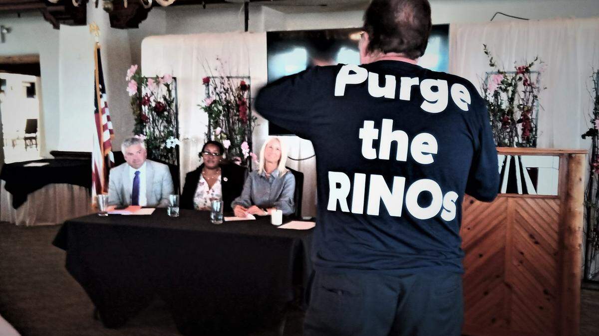 Pachyderm Club member Ed Myers confronts panelists Kelly Arnold, Talia Penn and Renee Erickson during a Friday meeting about proposed changes to Kansas Republican Party rules.