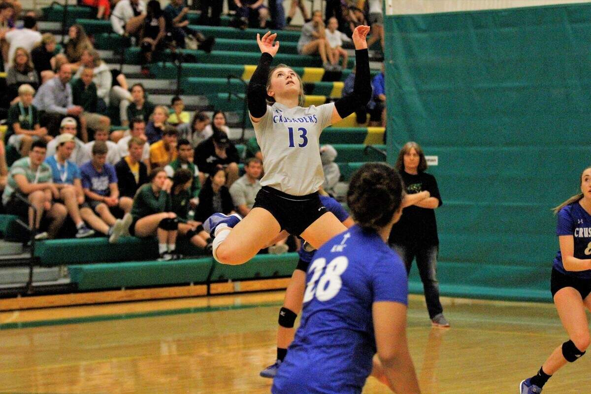 Kapaun junior libero Ryen Wilkens (13) leaps for a set during the Crusaders triangular with Bishop Carroll and Wichita East on Tuesday. (Sept. 4, 2018)