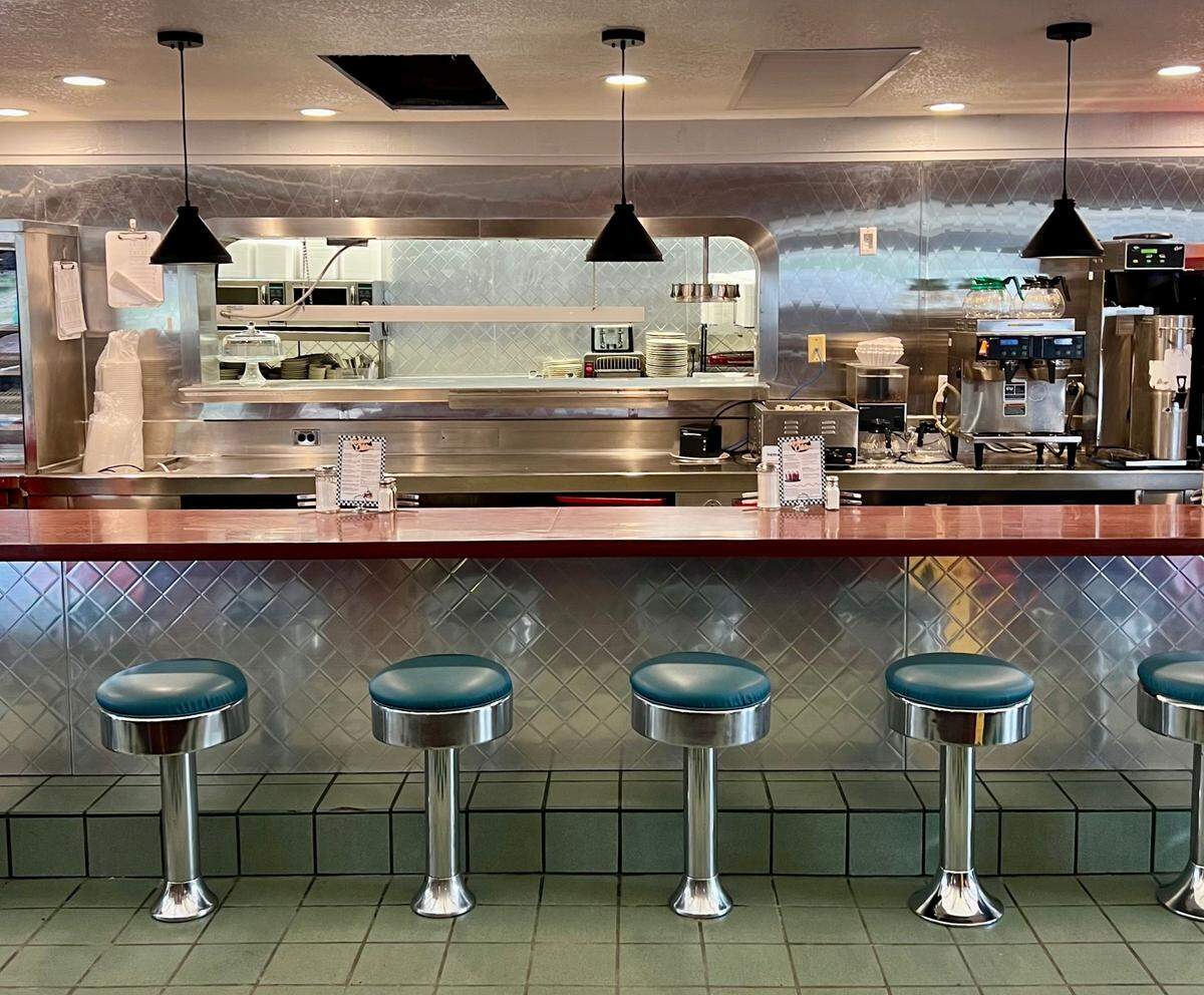 While repairing the restaurant from fire damage, the owners of Jimmie’s Diner removed heavy wooden beams above the dining counter.