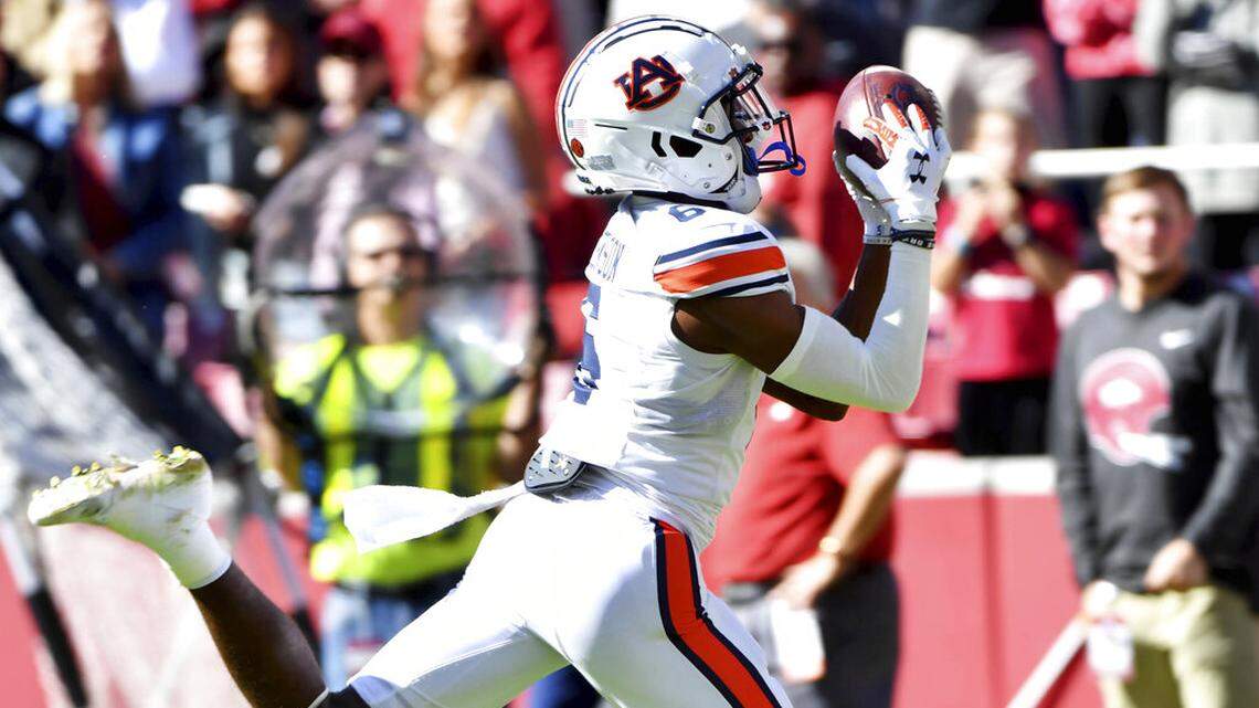 Auburn receiver Ja’Varrius Johnson (6) scores a touchdown against Arkansas during the first half of an NCAA college football game Saturday, Oct. 16, 2021, in Fayetteville, Ark. (AP Photo/Michael Woods)