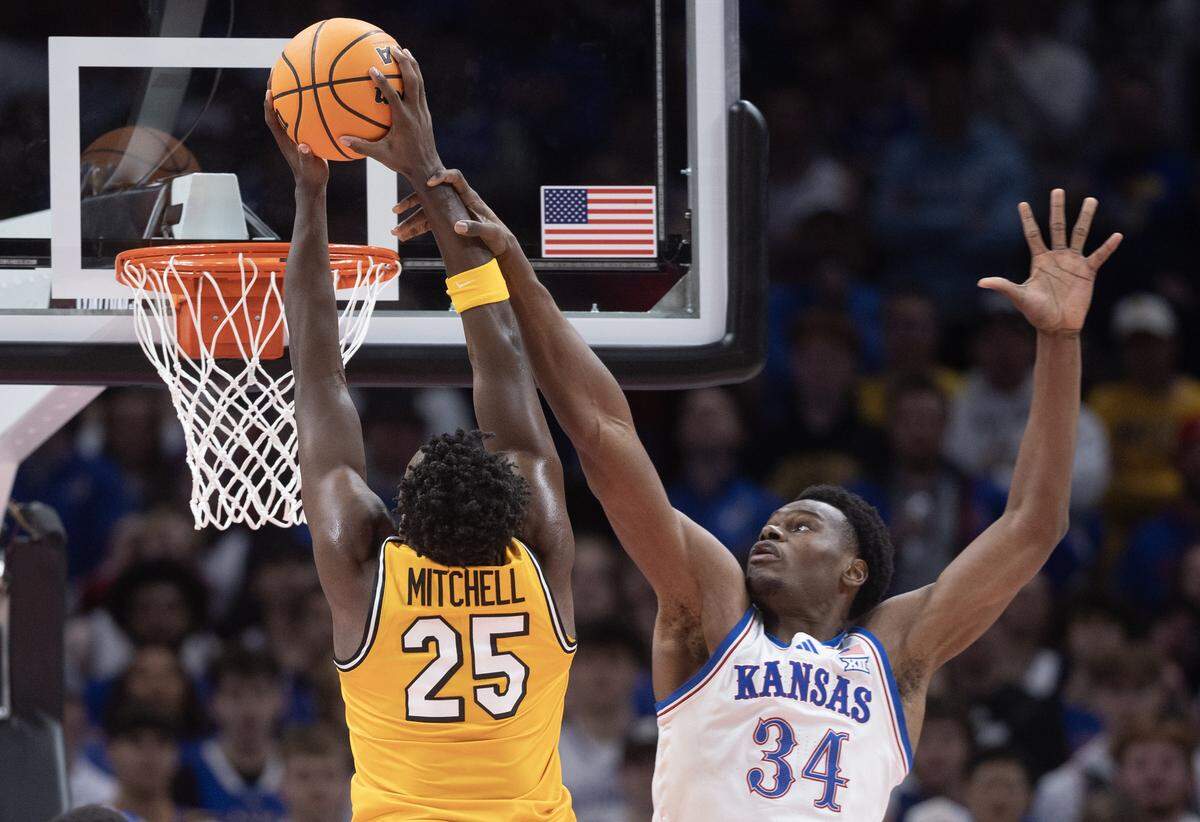 Kansas’ Paul Mbiya can’t stop Missouri’s Mark Mitchell from dunking during the first half of their game at T-Mobile Center on Sunday, Dec. 7, 2025.