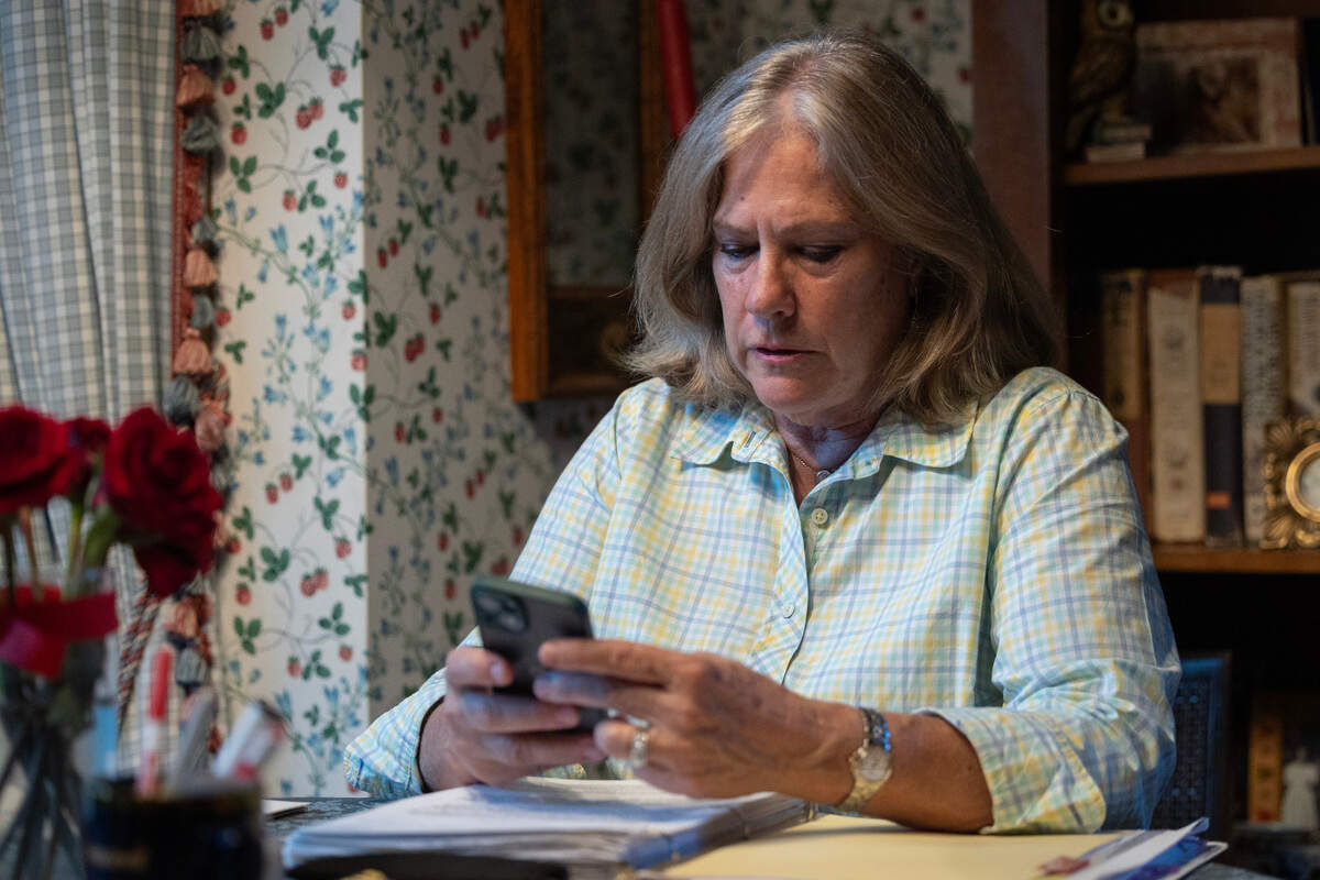 Celeste Racette checks her phone for election returns on Tuesday night. Racette defeated AlmaAnn Jones in the Democratic primary for the District 3 race for Sedgwick County Commission.