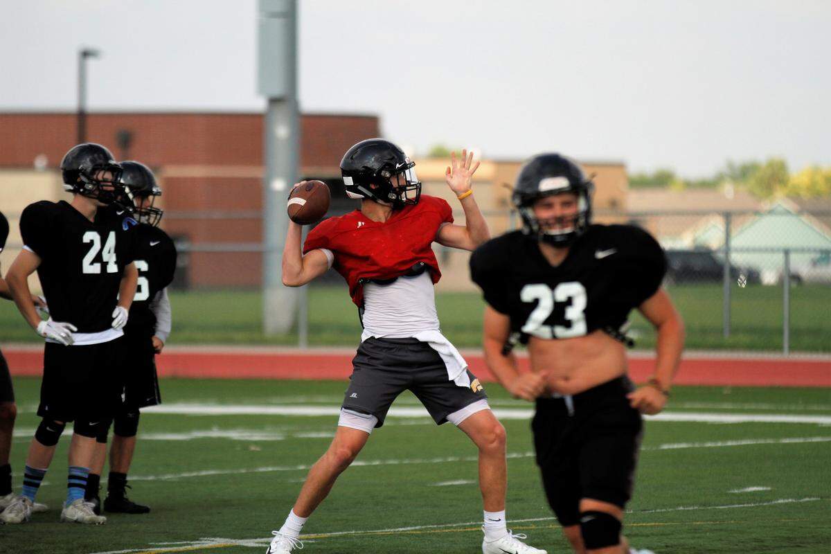 Eisenhower’s Collin Mackey drops back during fall practice.
