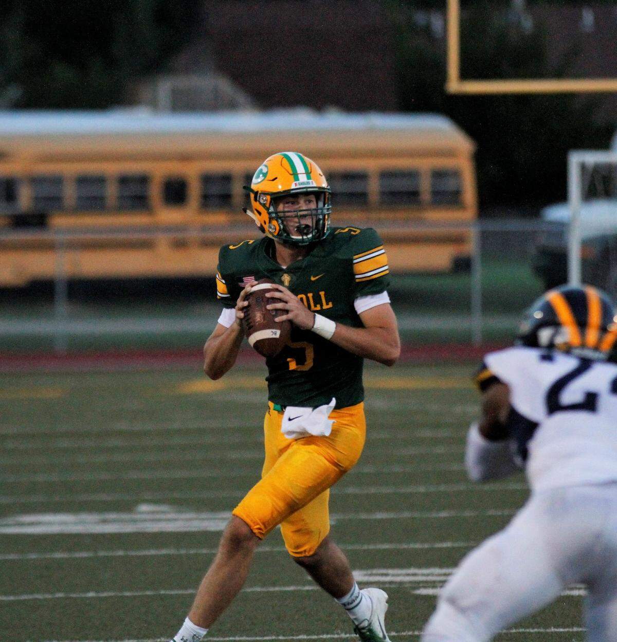 Bishop Carroll senior quarterback Cade Becker rolls out for a pass against Wichita Northwest during the Grizzlies 23-22 win over the Golden Eagles on Friday night. (Aug. 31, 2018)