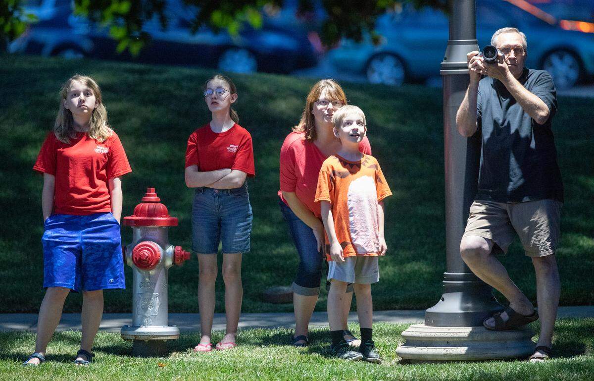 A family gathers to watch the purple martin show at the Waterfront Development.