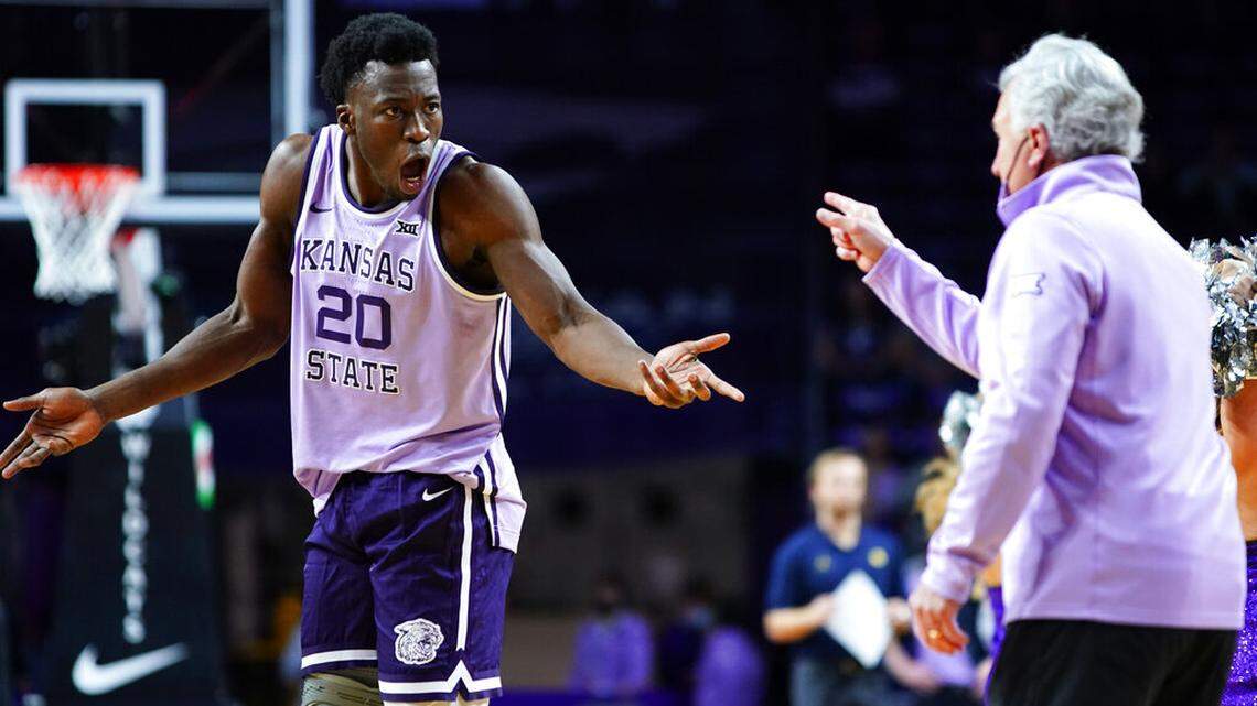 Kansas State forward Kaosi Ezeagu, left, gestures during a conversation with coach Bruce Weber during the second half of the team’s NCAA college basketball game against Marquette on Wednesday, Dec. 8, 2021, in Manhattan, Kan. (AP Photo/Nick Krug)