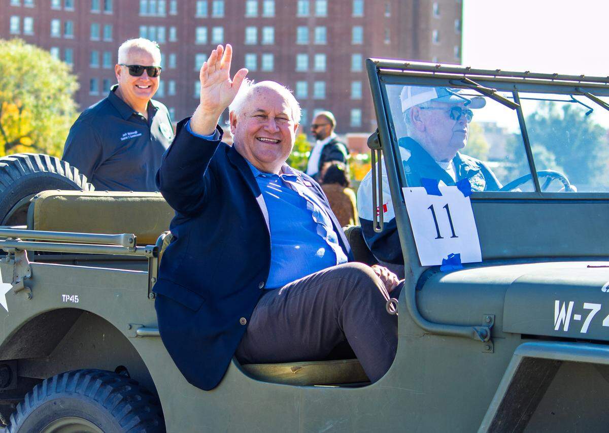 U.S. Rep. Ron Estes waves while riding in a military vehicle in Wichita's 2025 Veterans Day parade.