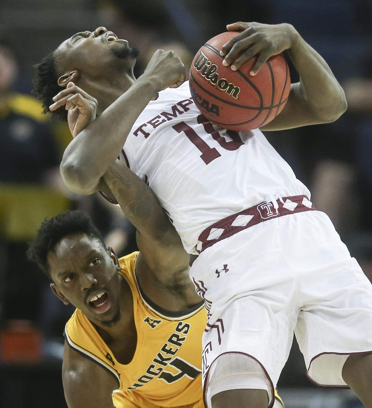 Wichita State guard Samajae Haynes-Jones gets tangled up with Temple guard Shizz Alston Jr. during the second half of their American Athletic Conference quarterfinal game in Memphis on Friday.