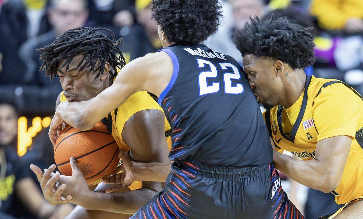 Wichita State’s Noah Hill steals the ball from DePaul’s Kruz McClure, with help from teammate Kenyon Giles, during the first half on Dec. 13 at Koch Arena.