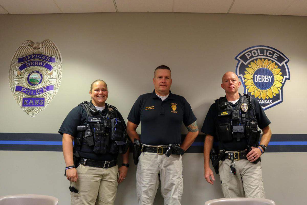 Officer Kayla Sanders, Sgt. Chad Carson and master police officer Chris West of the Derby Police Department joined officer Rooshad Irani (not pictured) in replacing Joan Van Boening’s mailbox and bridge after a hit-and-run crash earlier this month.
