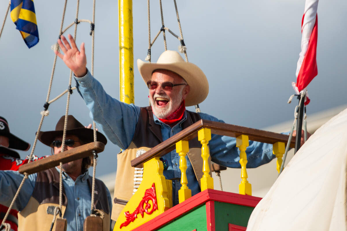 Volunteers on the Windwagon wave to the crowd of lining downtown Wichita on Friday at the start of the Star Lumber Sundown Parade The parade began on Main and ended on Market.