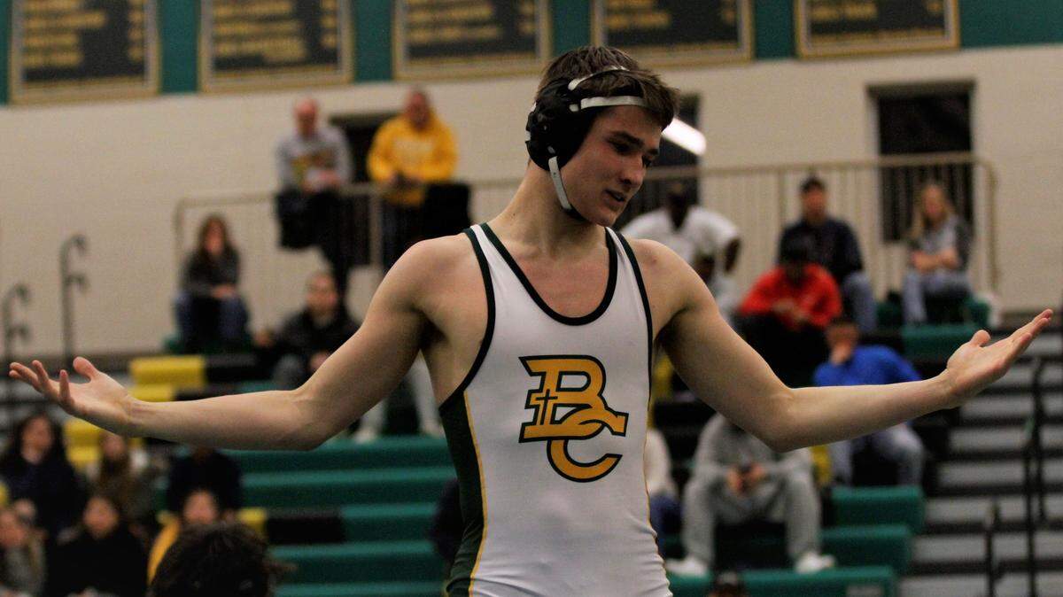 Bishop Carroll senior wrestler Jaleb Gann puts his arms out to the Golden Eagles fans after his final home bout Thursday against Wichita Northwest. (Feb. 7, 2019)