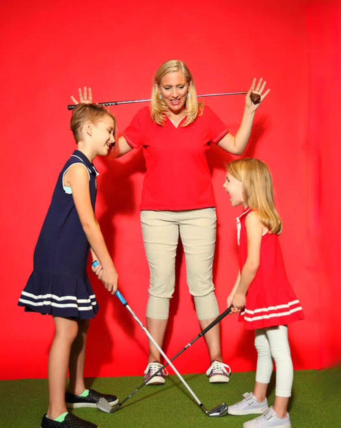 Amy McKee, shown with her daughters, Mia, left, and Madelina, said her family’s new Good Life Golf Lab is great for kids, beginners and more serious golfers.