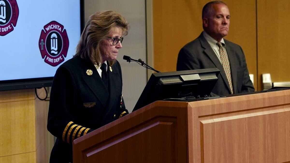 In this archive photo, Wichita Fire Department Chief Tammy Snow, flanked by WFD local union president Ted Bush, gives an update where a firefighter died from their injuries while combating a house fire.