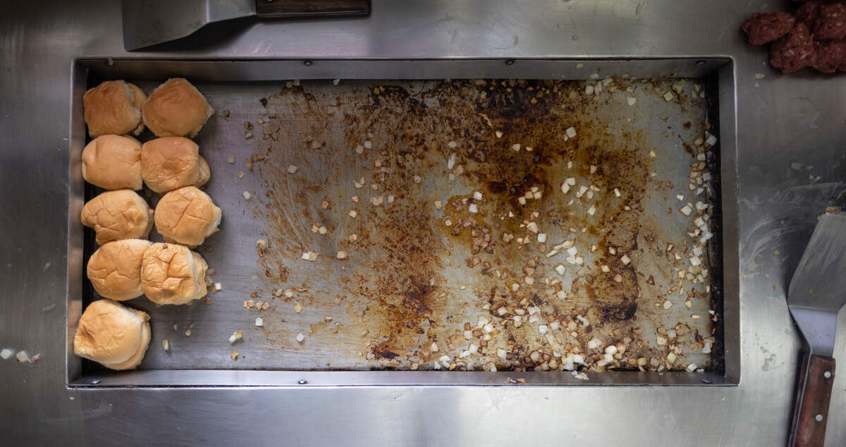An around 1,300 hamburger sliders a day are cooked on this grill at The Cozy Inn.