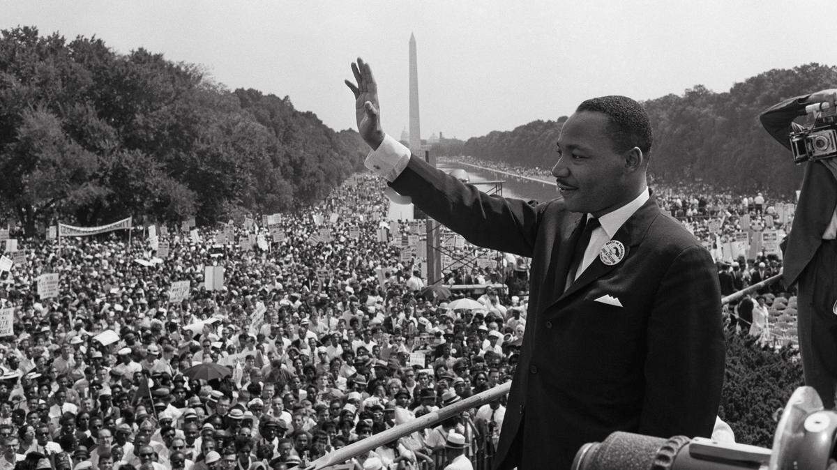 US civil rights leader Martin Luther King (C) waves to supporters on August 28, 1963 on the Mall in Washington DC (Washington Monument in background) during the "March on Washington", where King delivered his famous "I Have a Dream" speech, which mobilized supporters of desegregation and prompted the Civil Rights Act of 1964. King said the march was "the greatest demonstration of freedom in the history of the United States." Martin Luther King was assassinated on 04 April 1968 in Memphis, Tennessee. James Earl Ray confessed to shooting King and was sentenced to 99 years in prison. King's killing sent shock waves through American society at the time, and is still regarded as a landmark event in recent US history. (Photo by AFP) (Photo by -/AFP via Getty Images)