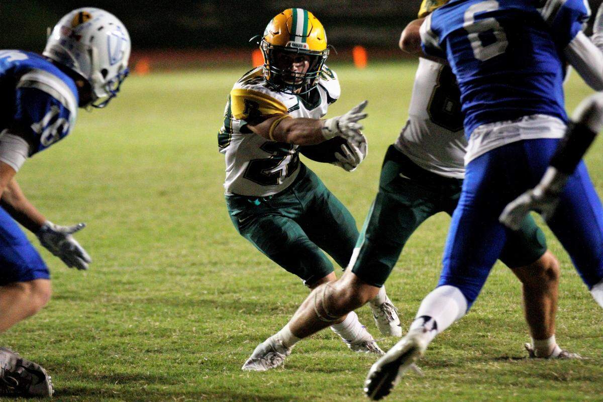 Jackson Nichols, a Bishop Carroll senior running back, hits the hole during the Golden Eagles’ 28-14 win at Kapaun on Friday. (Oct. 5, 2018)