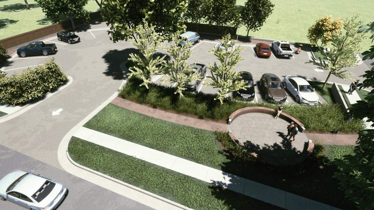 This is an aerial view, including a walking path and circular bench, of the parking lot the Happiness Plaza owners want to build after demolishing houses near the development.