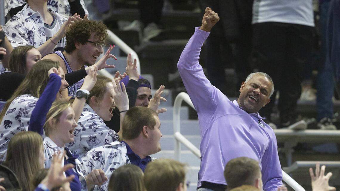Kansas State coach Jerome Tang, right, celebrates with fans in the stands after his team defeated Iowa State in an NCAA college basketball game Saturday, Feb. 18, 2023, in Manhattan, Kan.