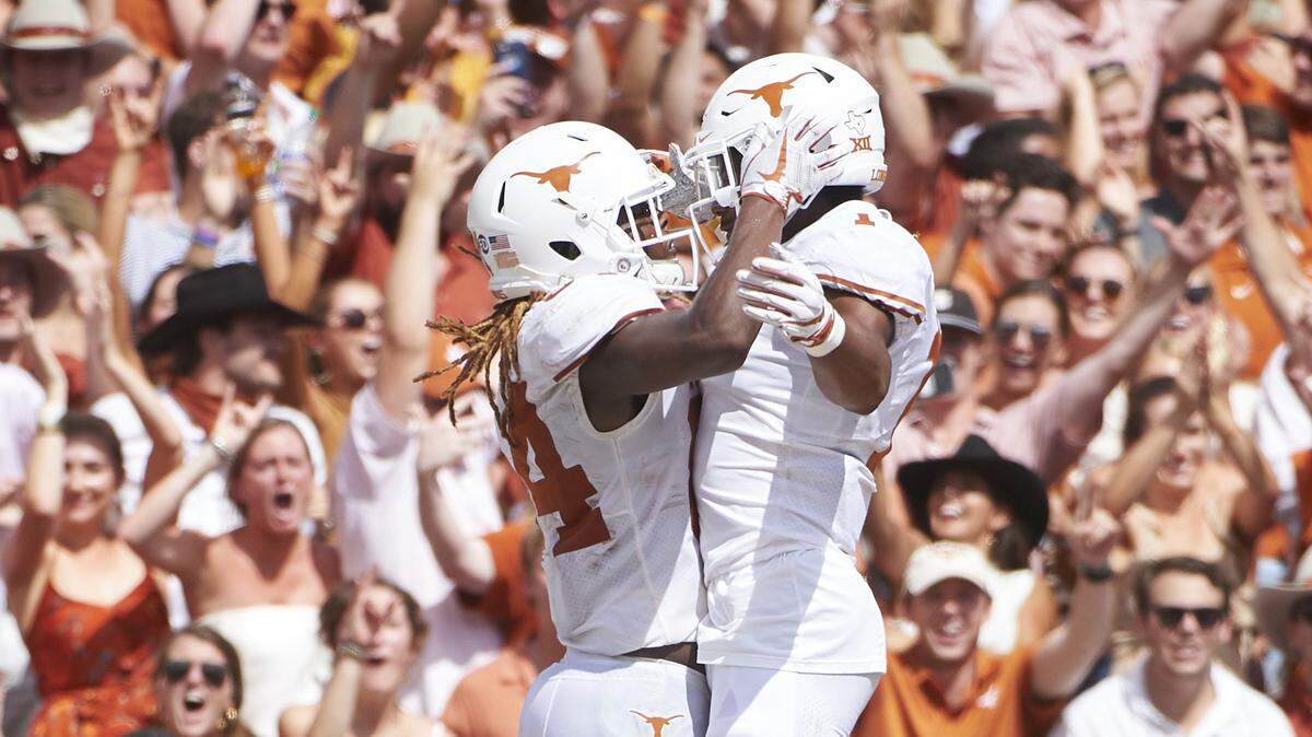 Texas wide receiver Lil’Jordan Humphrey, left, celebrates with teammate John Burt (1) after scoring a touchdown on a 15-yard reception  against Oklahoma during the second half Saturday at the Cotton Bowl.