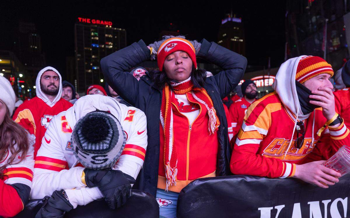 Chiefs fans react in downtown Kansas City on Sunday night after Patrick Mahomes threw his second interception of the game in the second quarter.