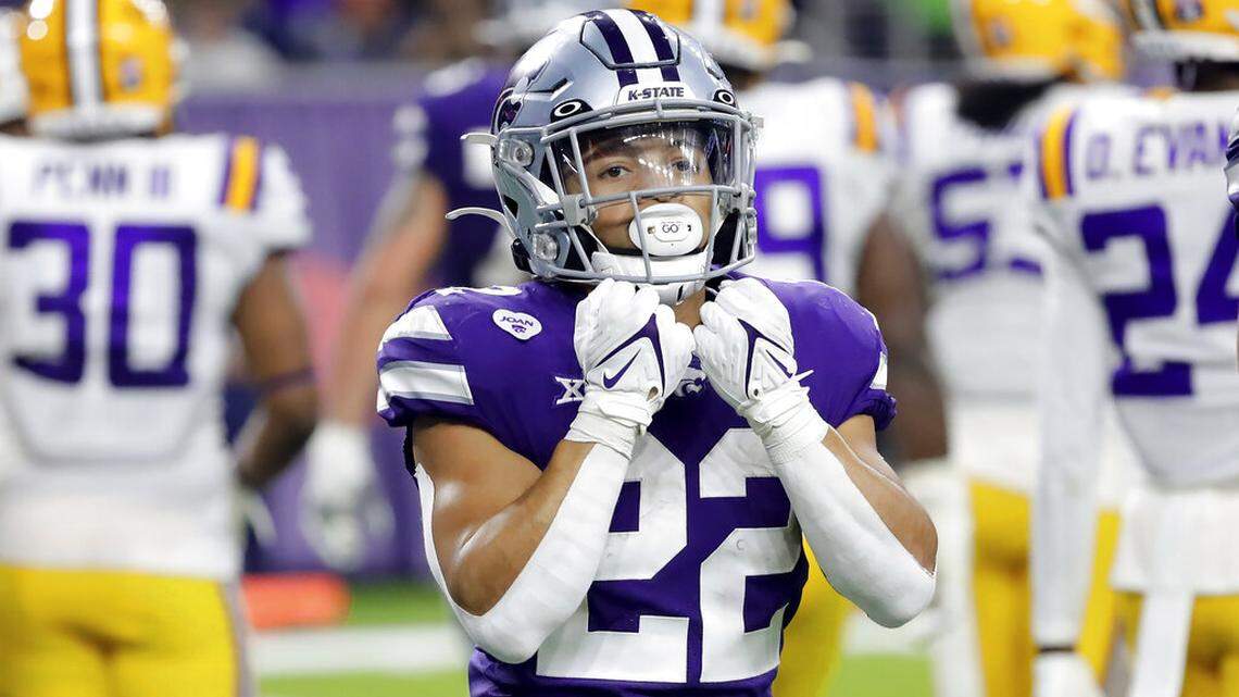 Kansas State running back Deuce Vaughn (22) gestures to the stands after scoring during the second half of the Texas Bowl NCAA college football game against LSU Tuesday, Jan. 4, 2022, in Houston. (AP Photo/Michael Wyke)