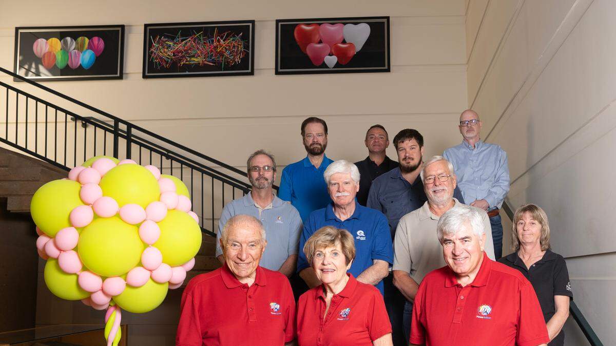 Pioneer Balloon owners Ted A. Vlamis and Betty Vlamis, front left, and their son, Ted J. Vlamis, front right. Behind them are some of their 900 worldwide employees. Pioneer Balloon is restructuring through Chapter 11 bankruptcy following what Ted A. Vlamis called the ravages of the pandemic.