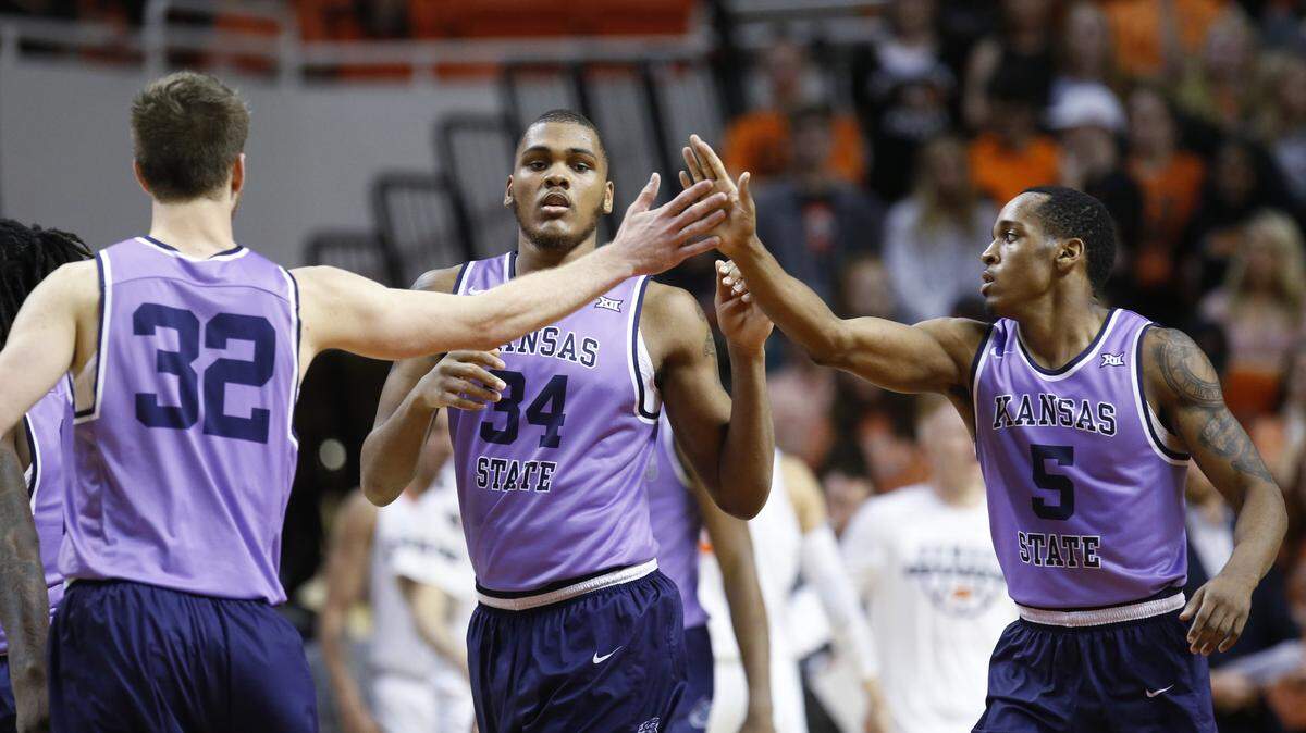 Kansas State forward Dean Wade (32), forward Levi Stockard III (34) and guard Barry Brown (5) celebrated as they walked off the court during a timeout in the second half of an NCAA college basketball game against Oklahoma State in Stillwater, Okla., Wednesday, Feb. 14, 2018. (AP Photo/Sue Ogrocki)