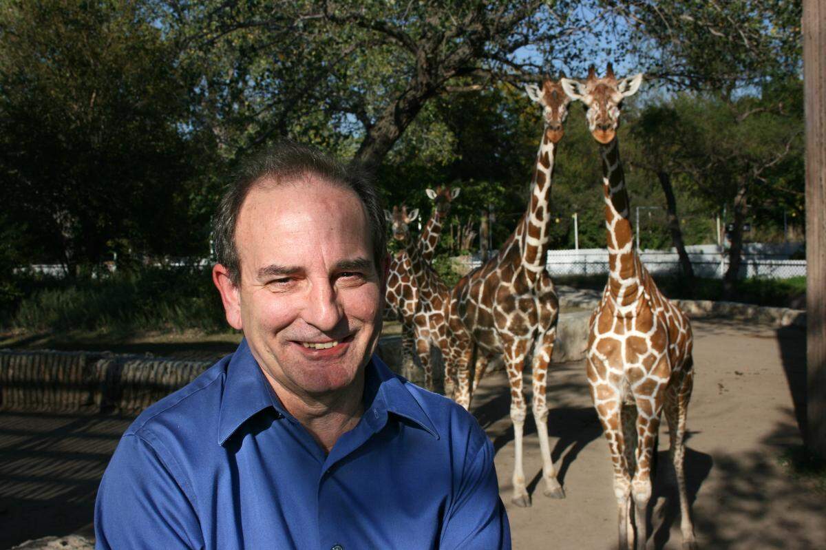 Longtime Sedgwick County Zoo executive director Mark Reed particularly loved large, African mammals, including these giraffes, even though they seem to be sticking out their tongues at him.