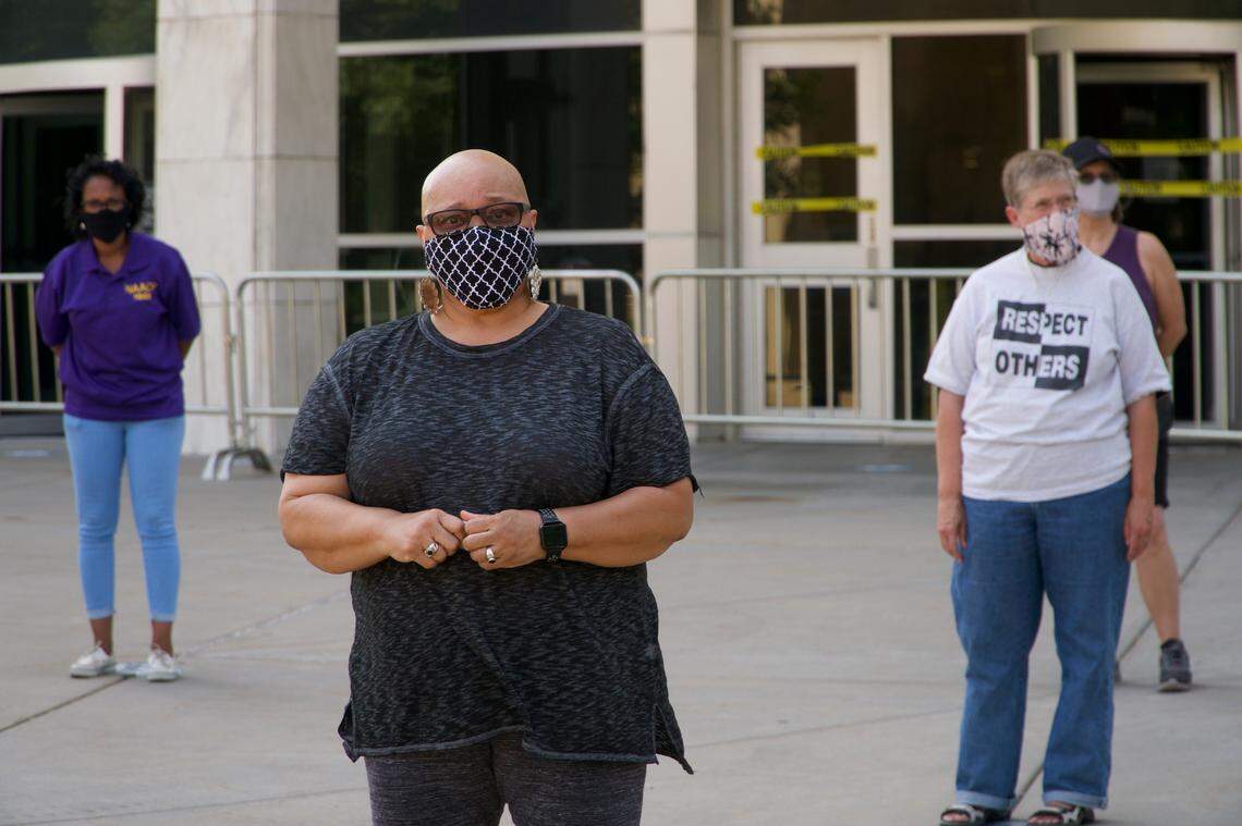 Mary Dean, center, was with a dozen other people in front of the Sedgwick County building to show support for Gov. Laura Kelly’s mandate to wear masks.