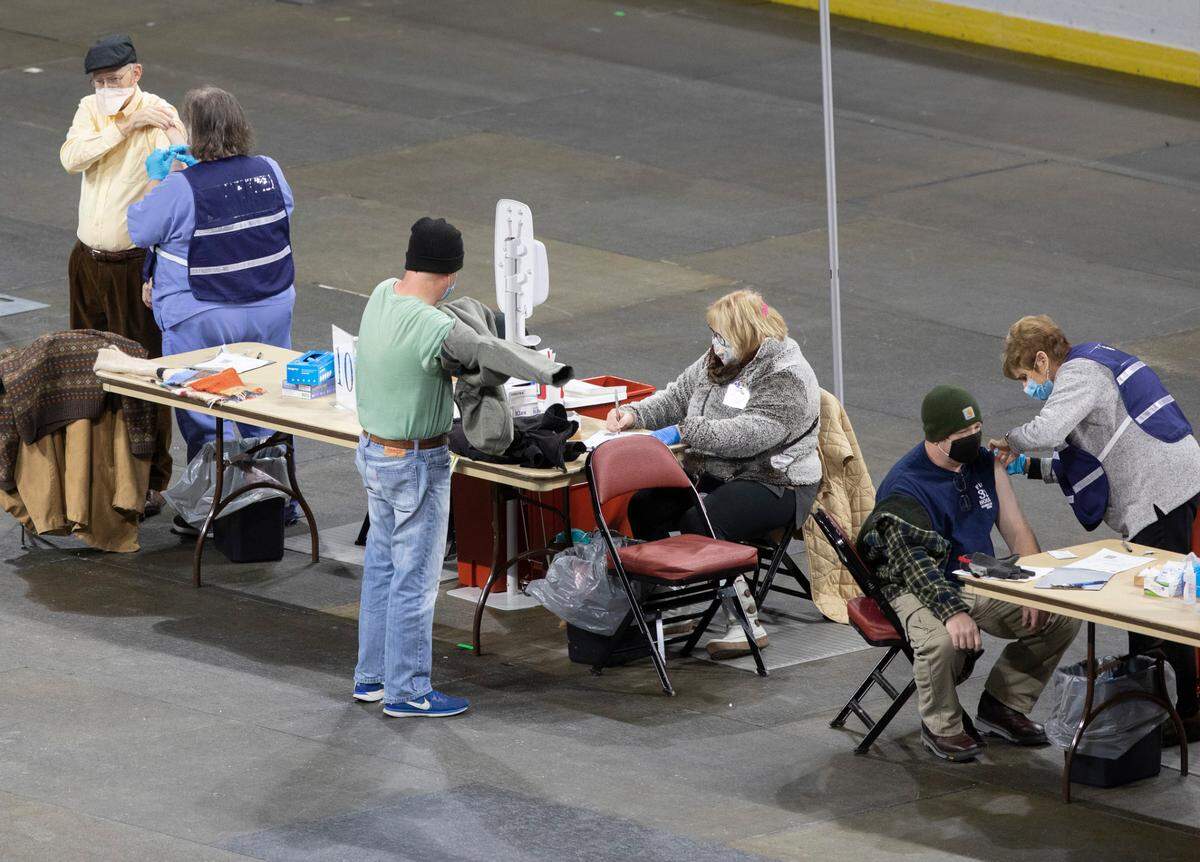 Sedgwick County’s COVID-19 vaccination station at Intrust Bank Arena has moved to the covered up hockey ice floor opening up a lot more space so people can wait inside during the frigid temperatures. The shots were previously being given in the concourse with an outdoor overflow. (February 9, 2021)