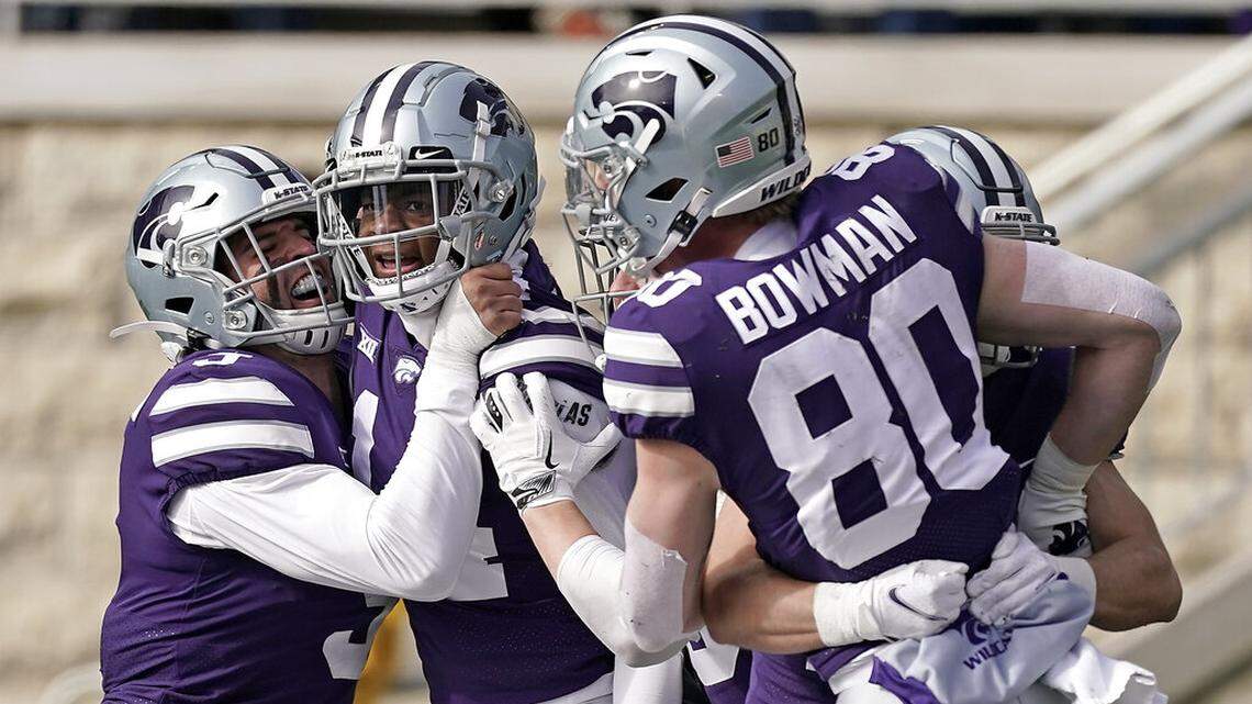 Kansas State defensive back Marvin Martin, center, celebrates with teammates after after he recovered a punt blocked by wide receiver Ty Bowman (80) and ran for a touchdown during the first half of an NCAA college football game against West Virginia, Saturday, Nov. 13, 2021, in Manhattan, Kan. (AP Photo/Charlie Riedel)