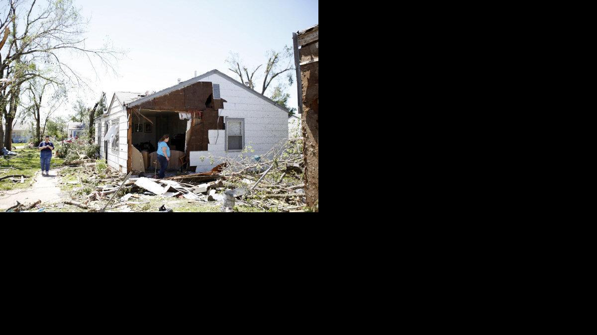 Chrissy Hart stands in her living room. The April 14, 2012 tornado blew off the entire wall of her Oaklawn home. She was not home at the time. (April 15, 2012)


