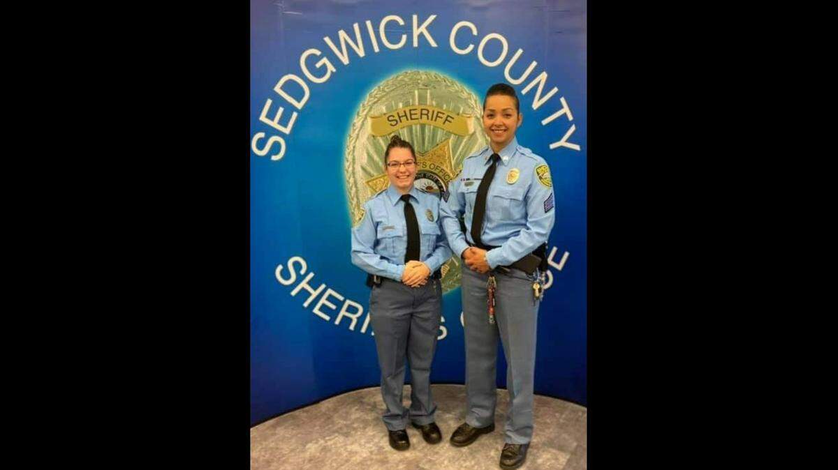 Sidnee Carter (left) poses with one of her instructors, Fabiola Torres, after finishing schooling to become a jail deputy in Sedgwick County.