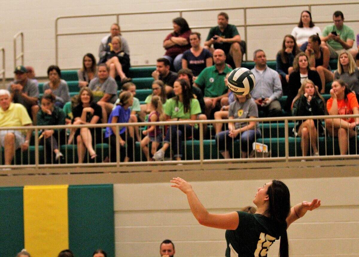 Carroll senior middle hitter Britney Ho serves during the Golden Eagles’ triangular with Kapaun Mt. Carmel and Wichita East on Tuesday. (Sept. 4, 2018)