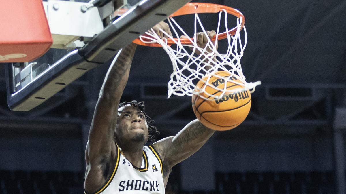 Wichita State’s Jaykwon Walton dunks the ball on a alley-oop pass from teammate Craig Porter Jr., during the first half against Central Florida earlier this season.