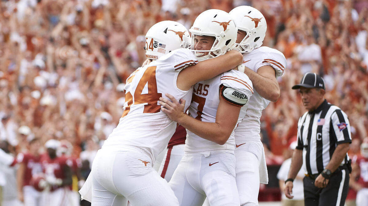 Texas kicker Cameron Dicker (17) celebrates with teammates after kicking the game-winning field goal in the closing seconds of the second half of an NCAA college football game against Oklahoma at the Cotton Bowl, Saturday, Oct. 6, 2018, in Dallas. Texas won 48-45. (AP Photo/Cooper Neill)