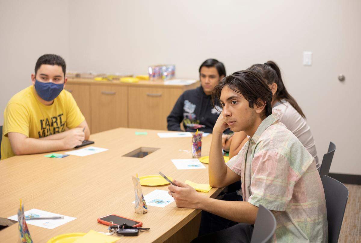 Students listen during the first Somos First-Gen meeting at the Evergreen Community Center and Library on on March 25, 2022.