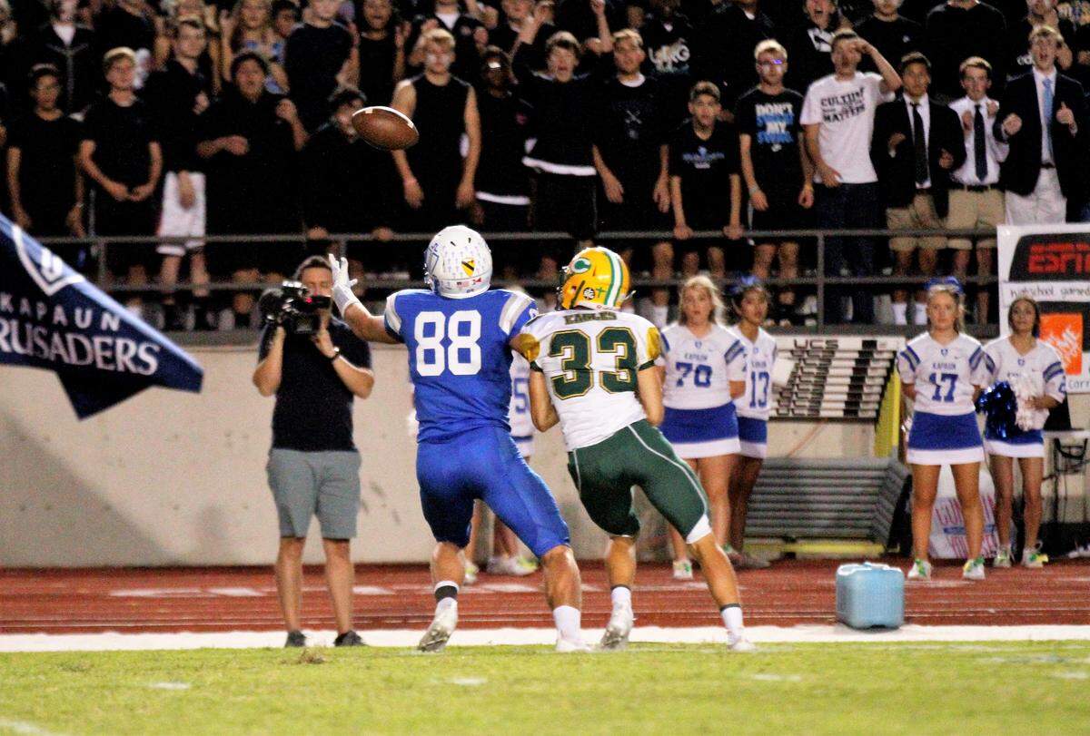 Kapaun senior tight end Jacob Schmitz looks to reel in a bobbled ball against Bishop Carroll during the Golden Eagles’ 28-14 win at Kapaun on Friday. (Oct. 5, 2018)