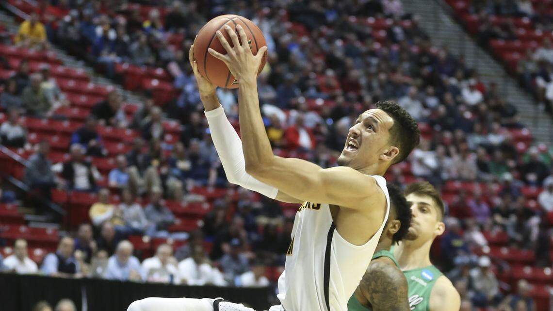 Wichita State guard Landry Shamet goes to the basket against Marshall guard Jarrod West during the first half Friday at the NCAA Tournament in San Diego. Shamet, the team's leading scorer this season as a sophomore, would further deplete the Shockers' senior-heavy roster if he chooses to enter the NBA Draft.