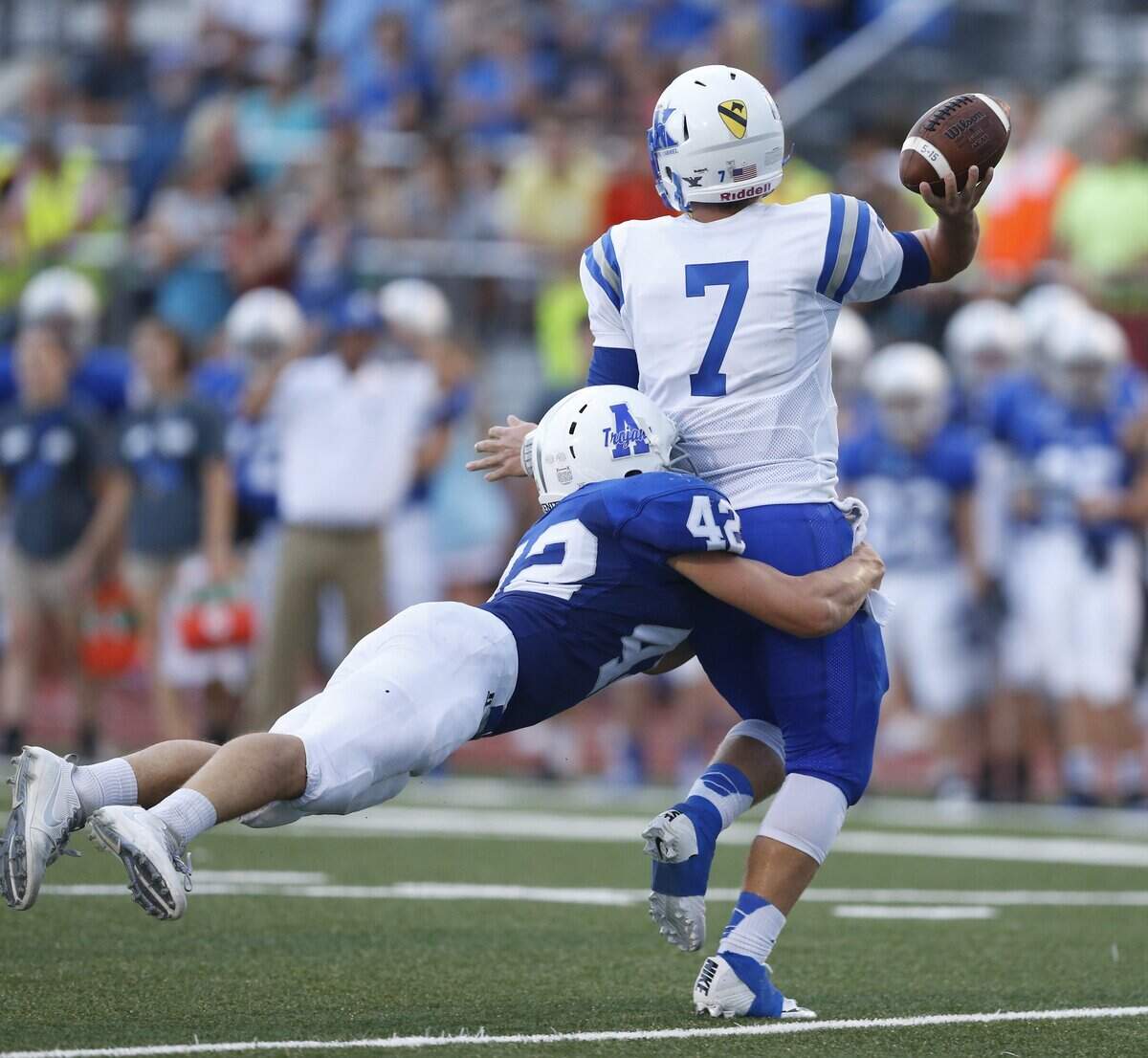 Andover defender #42 Casey Mayes grabs Kapaun quarterback #7 Nick Degenhardt  as he tries to get a pass off Friday evening. (September 8, 2016)