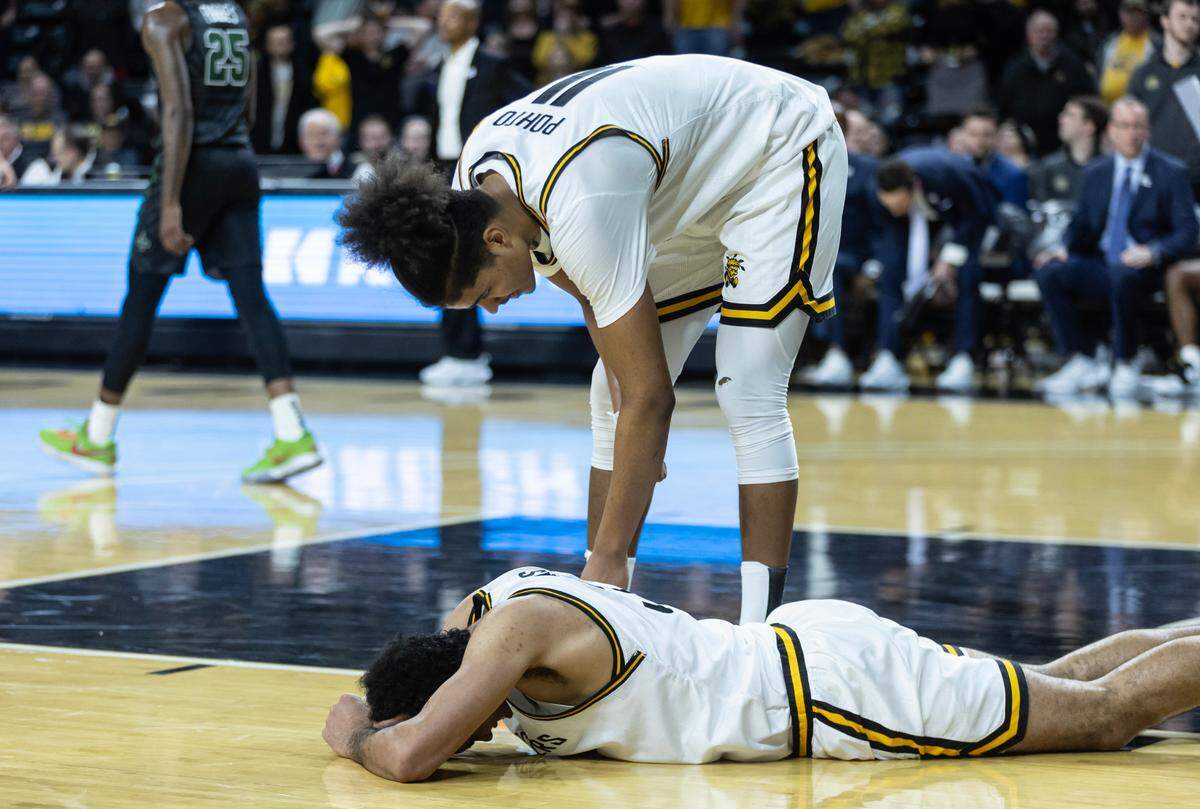 Wichita State’s James Rojas reacts after a bad play against Tulane while teammate Kenny Pohto looks in on him.