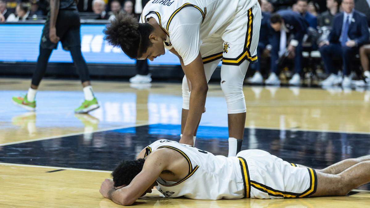 Wichita State’s James Rojas reacts after a bad play against Tulane while teammate Kenny Pohto looks in on him.