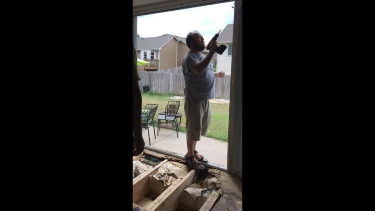 Britton Eichbauer working on his sister’s home after she found a soft and rotted spot on her back door.