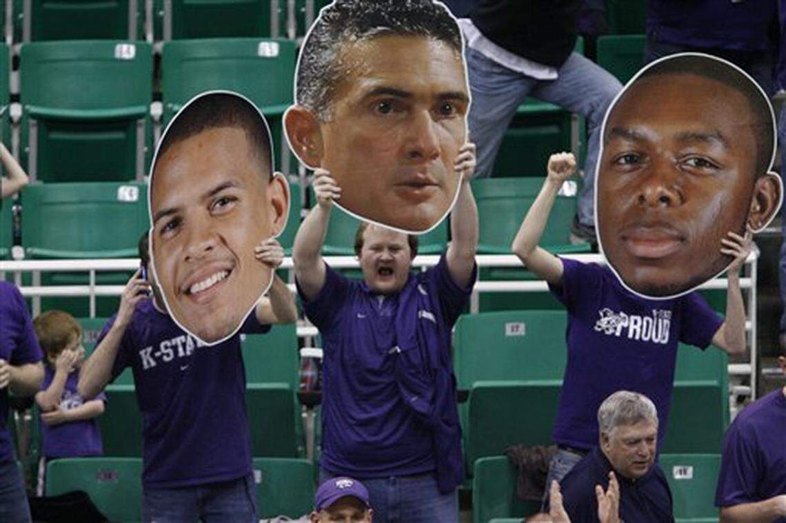 Fans in the stands hold giant heads of Kansas State’s Denis Clemente, left, head coach Frank Martin, center, and Jacob Pullen, right, as they celebrate an NCAA West Regional semifinal college basketball game victory over Xavier in Salt Lake City, Thursday, March 25, 2010. Kansas State beat Xavier, 101-96 in double overtime. (AP Photo/Steve C. Wilson)