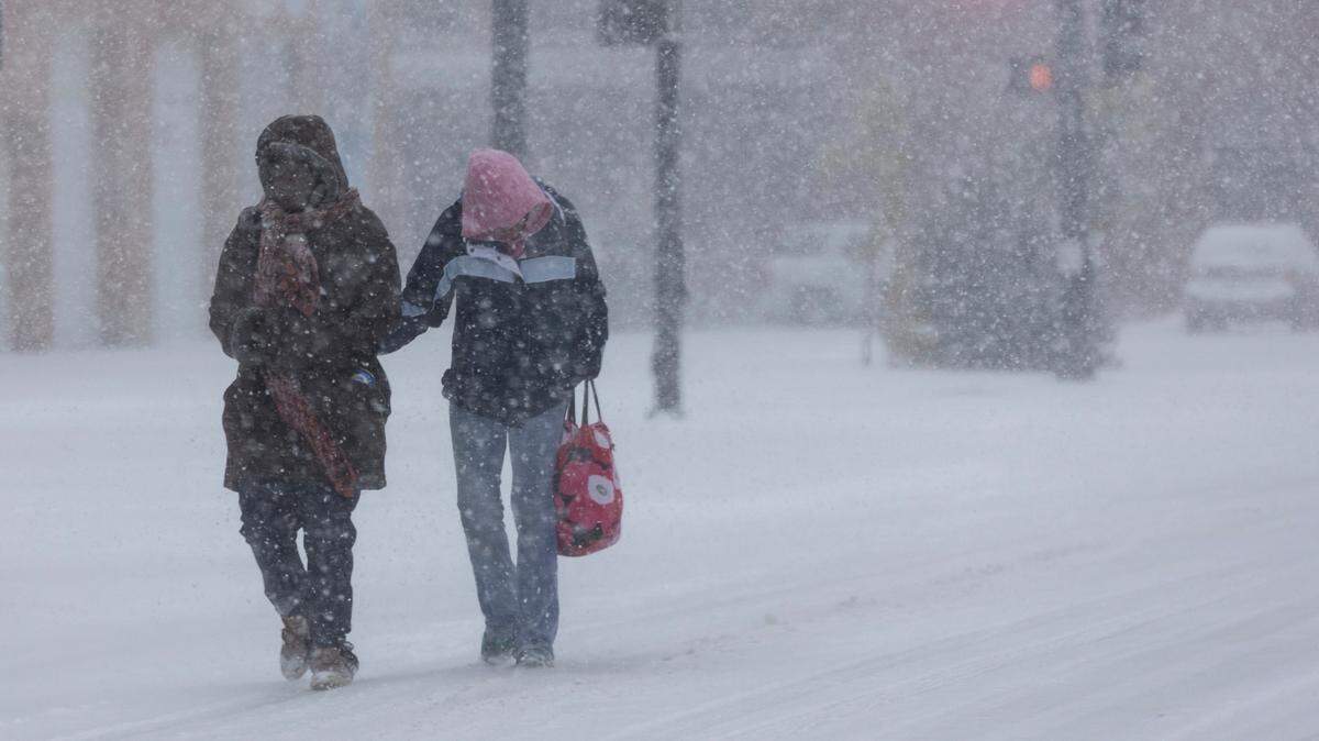 Two people make their way down Second Street on Thursday as a winter storm passes through Wichita.