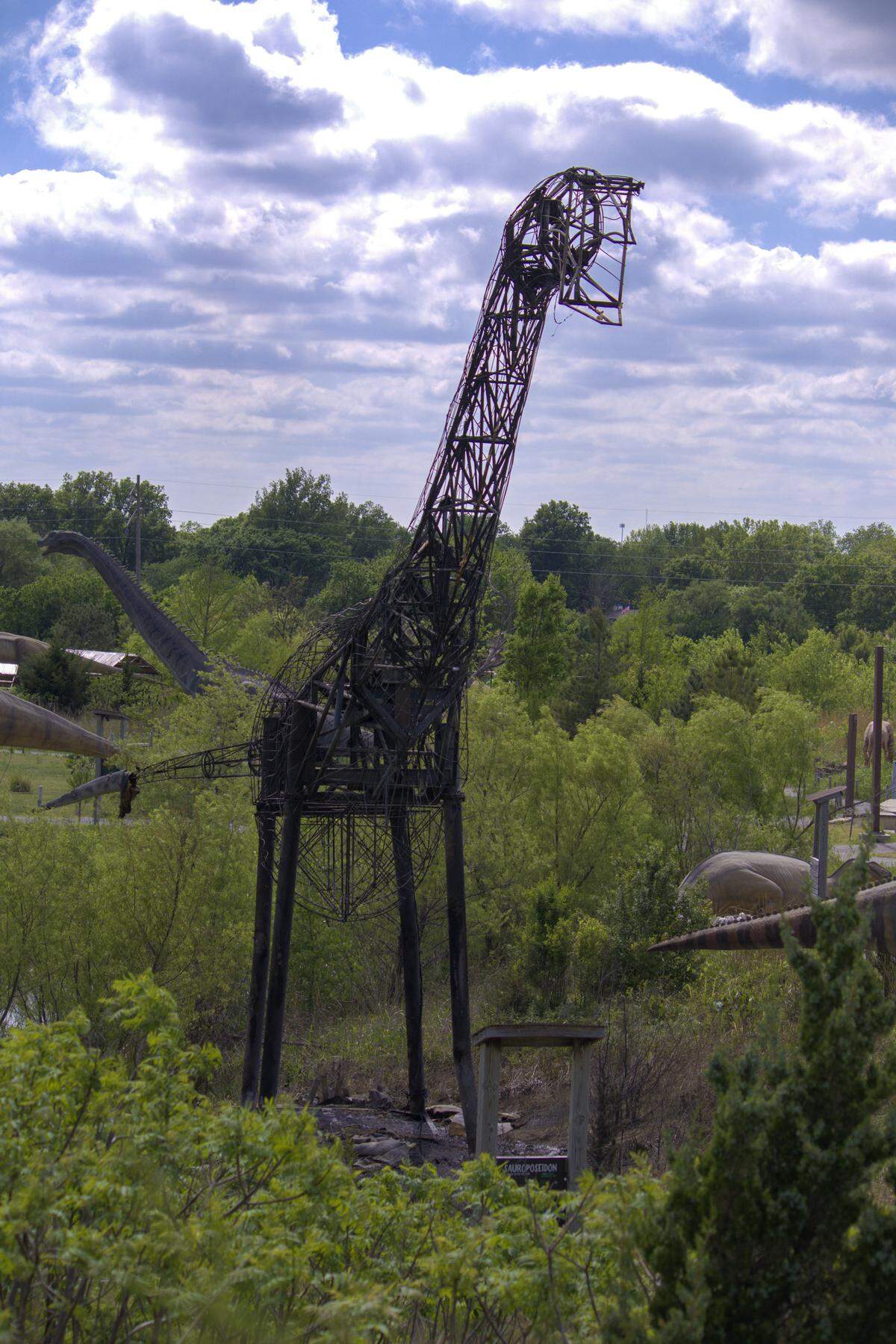 The Sauroposeidon animatronic, which weighed 60 tons, at Field Station: Dinosaur, was reduced to its frame after being struck by lightning and catching fire Saturday night. The metal skeleton of the dinosaur will remain with pictures of how the dinosaur was built for guests to view.