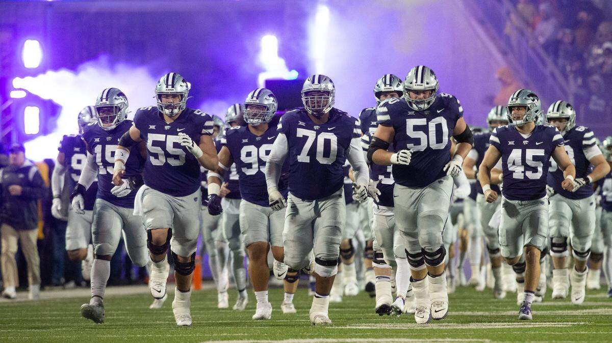 Kansas State players run out on to the field at Bill Snyder Family Stadium to take on Kansas during the Sunflower Showdown on Nov. 26.